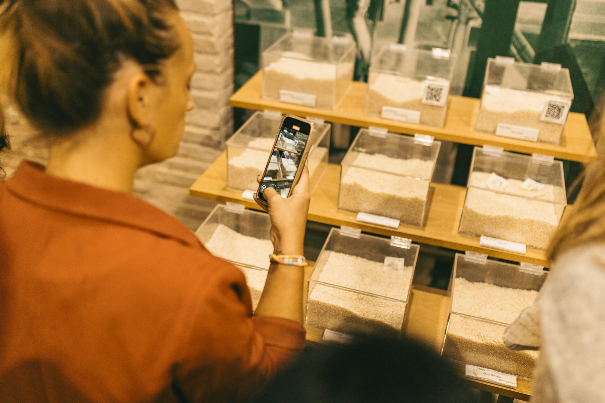 person taking pictures of different kinds of rice