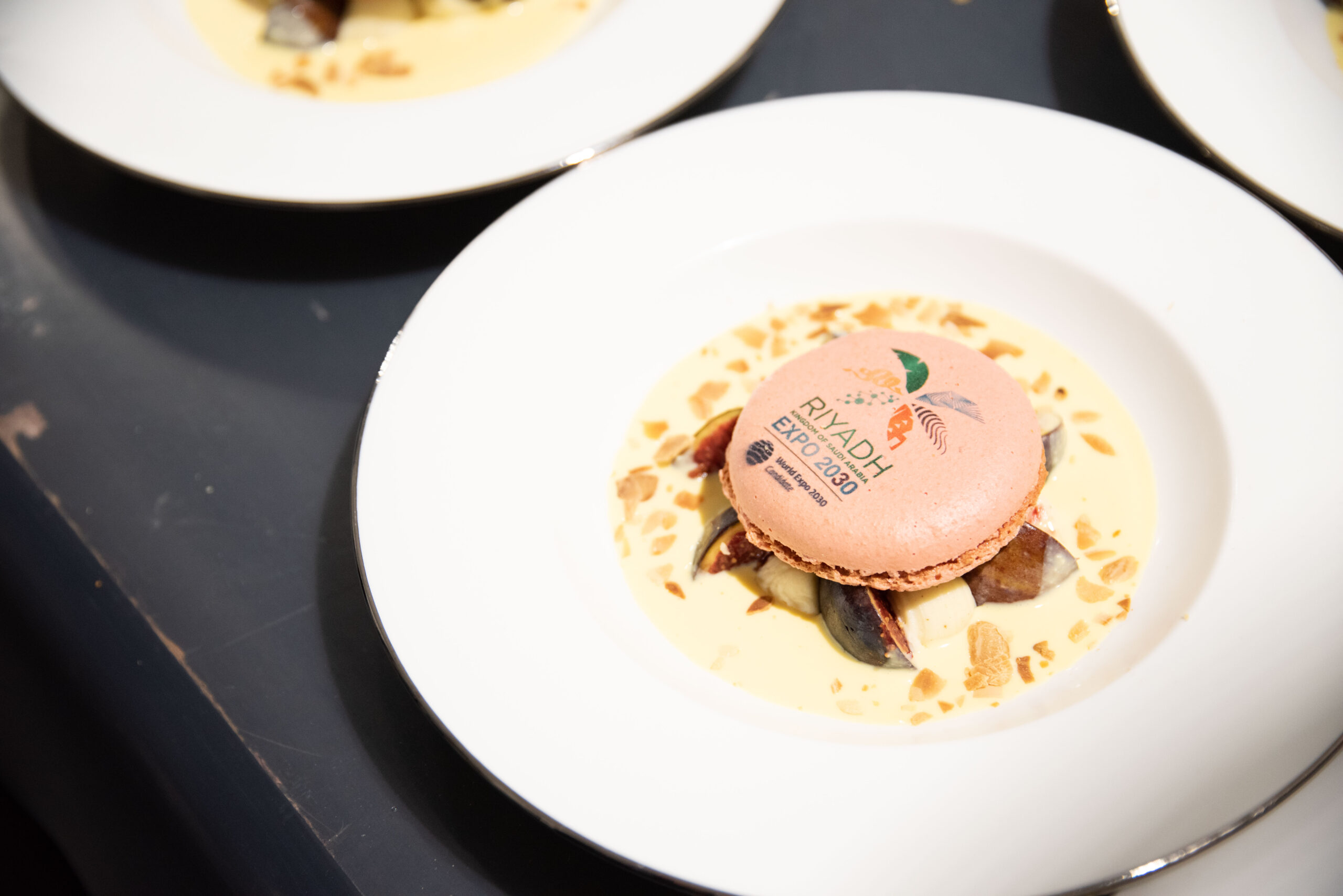 closeup of fancy food on plate with logo for Riyahd Expo 2030
